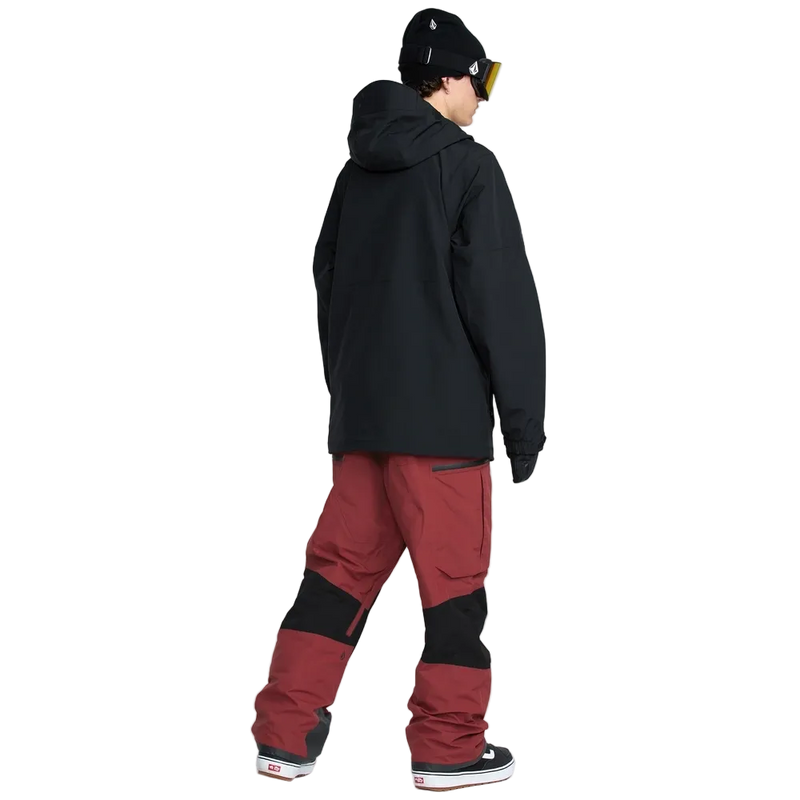 Rear, on-body image of the Rain Gore-Tex Bib Snowboard Pants from Volcom in Burnt Red paired with jacket.