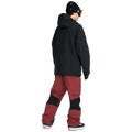 Rear, on-body image of the Rain Gore-Tex Bib Snowboard Pants from Volcom in Burnt Red paired with jacket.
