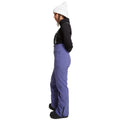 Side view of women wearing theRojo Softshell High Rise Ski Pants - Womens in colour Skipper Blue
