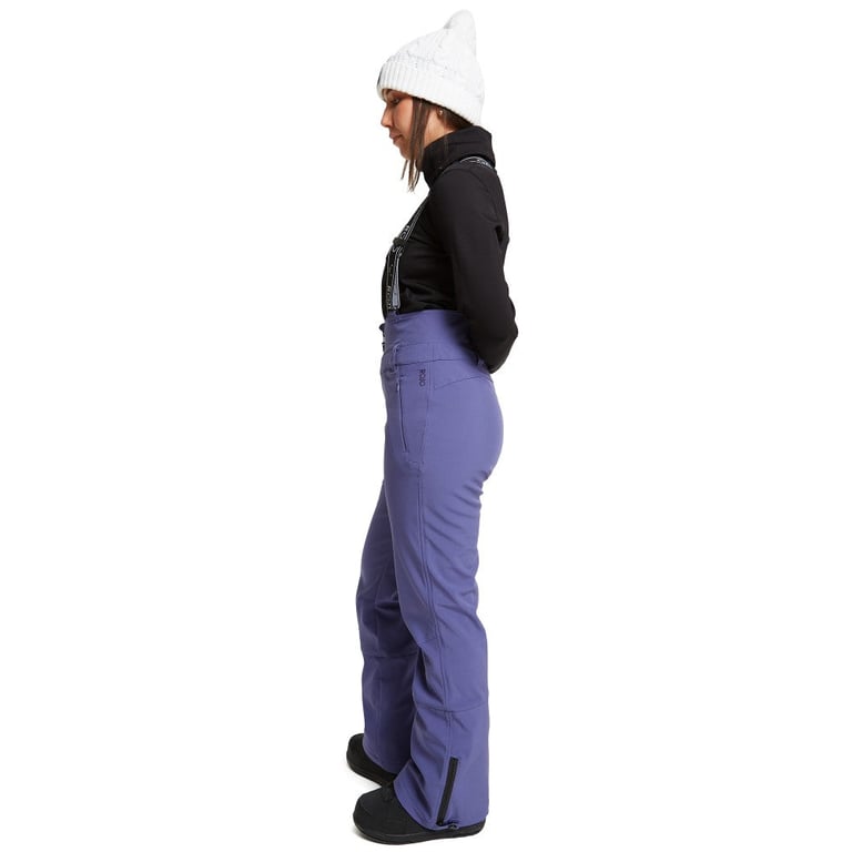 Side view of women wearing theRojo Softshell High Rise Ski Pants - Womens in colour Skipper Blue