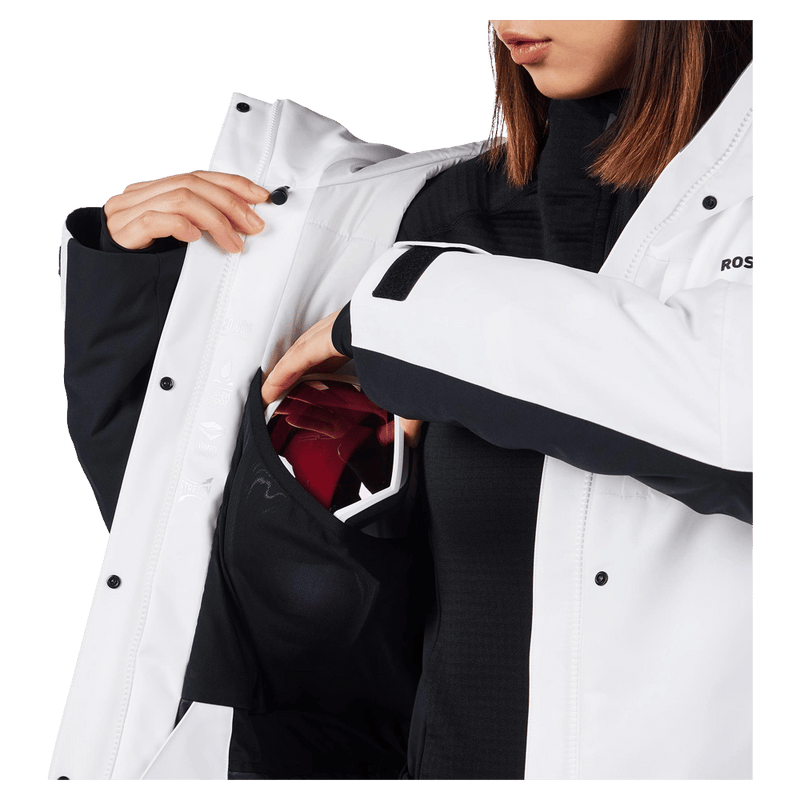 Goggle pocket view of the Rossignol VELIKA INSULATED Jacket in WHITE colourway, women model