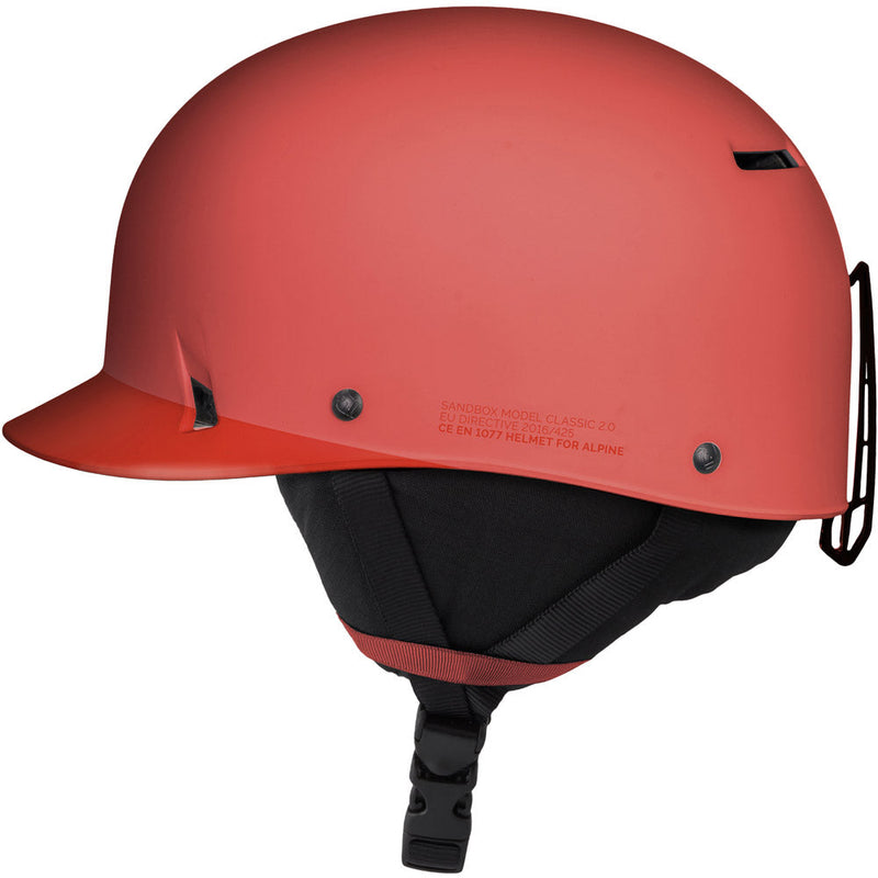 Side view of Sanbox Classic 1.0 Helmet in Vemillion colour, featuring removable goggle clip and ear pads