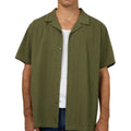Close view of Man wearing Silent Theory's Conquor SS Shirt in olive colourway