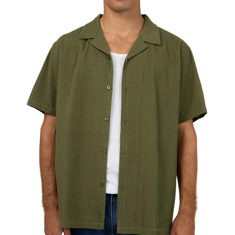 Close view of Man wearing Silent Theory's Conquor SS Shirt in olive colourway