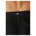 Afends black boardshorts with white contrast stitching and a small white leaf logo on the back waistband.
