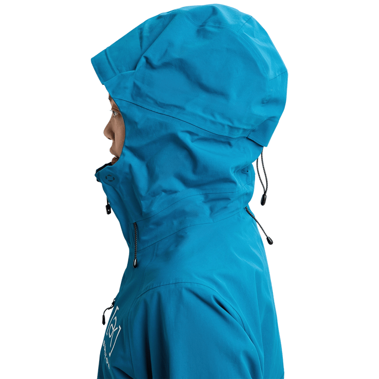 Side profile of a blue Burton AK Upshift Gore-Tex Snowboard Jacket with an adjustable hood and high collar.