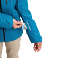 Blue Burton AK Upshift Gore-Tex jacket sleeve featuring a zippered pass pocket and white logo branding.