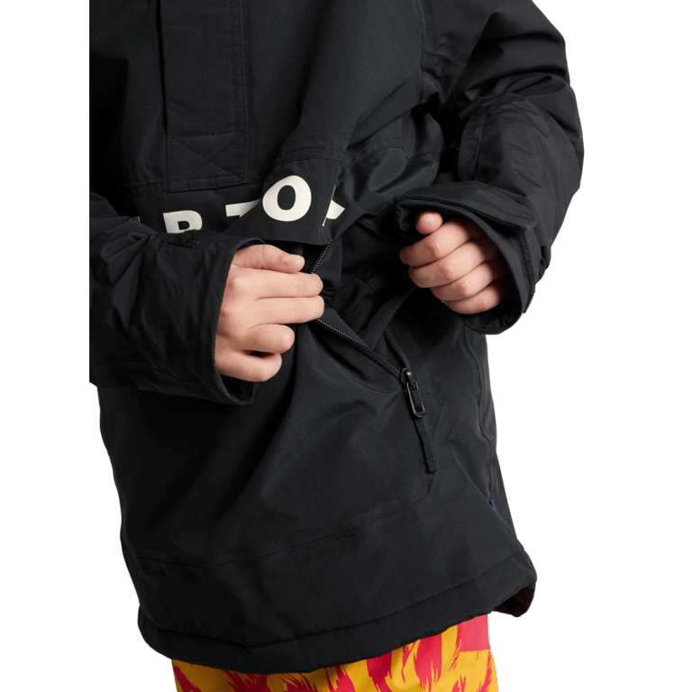 Black Burton Frostner Anorak kids' snowboard jacket showing a zippered side pocket and white logo on the chest flap.
