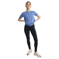Woman wearing dark grey Burton MP Active Leggings, a blue t-shirt, and white sneakers against a black background.