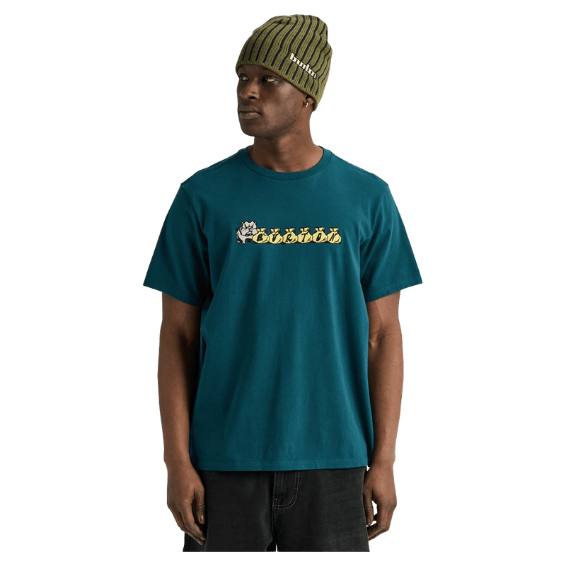 Teal Burton Ransacked short-sleeve t-shirt with a cartoon chest graphic on a man wearing an olive green beanie.