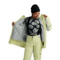 Woman wearing a pale yellow Burton Reserve 3-In-1 Snowboard Jacket showing the grey quilted inner liner.