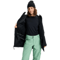 Woman wearing an open black Burton Reserve Insulated Snowboard Jacket showing the interior lining and powder skirt.