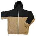 CHECKtheFeed VX Daily Snowboard Jacket in black and tan with white zipper, worn by a snowboarder on a snowy mountain.