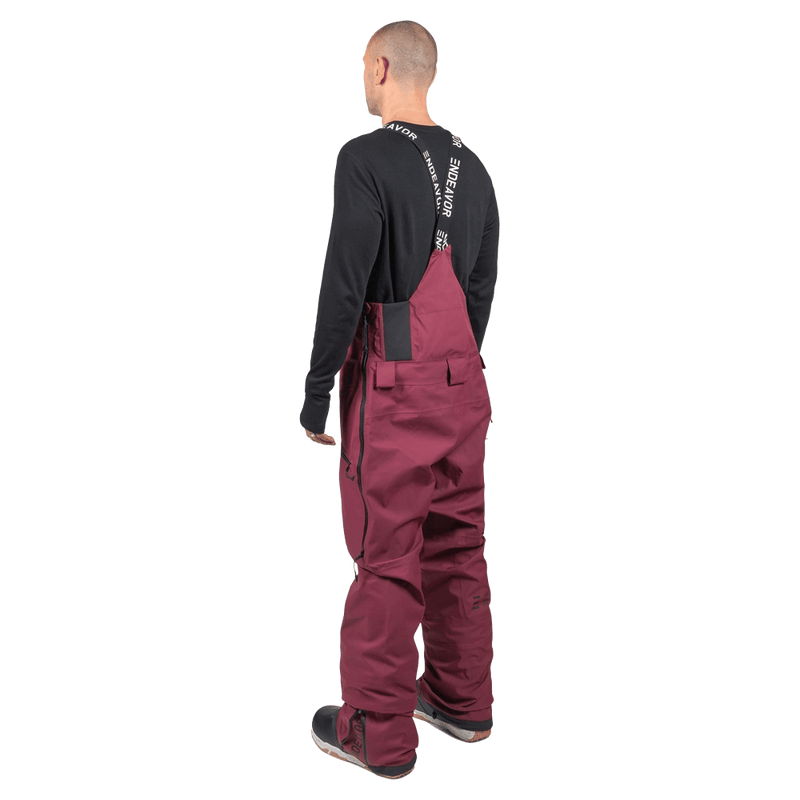 Maroon Endeavor 3L Shelter Bib snowboard pants from the back with branded suspenders and side leg zippers.