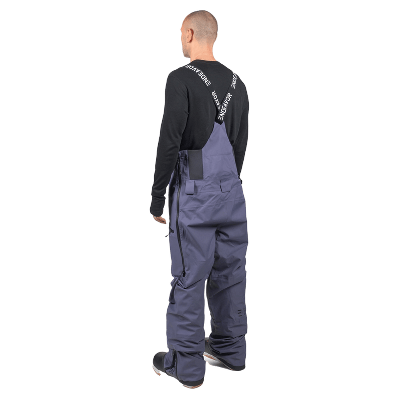 Rear view of slate blue Endeavor 3L Shelter Bib Snowboard Pants featuring branded suspenders and side ventilation zippers.