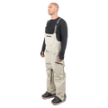 Beige Endeavor 3L Shelter Bib Snowboard Pants with black branded suspenders and zippered pockets shown on a male model.