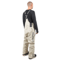Rear view of beige Endeavor 3L Shelter Bib Snowboard Pants with black branded suspenders and side zippers.