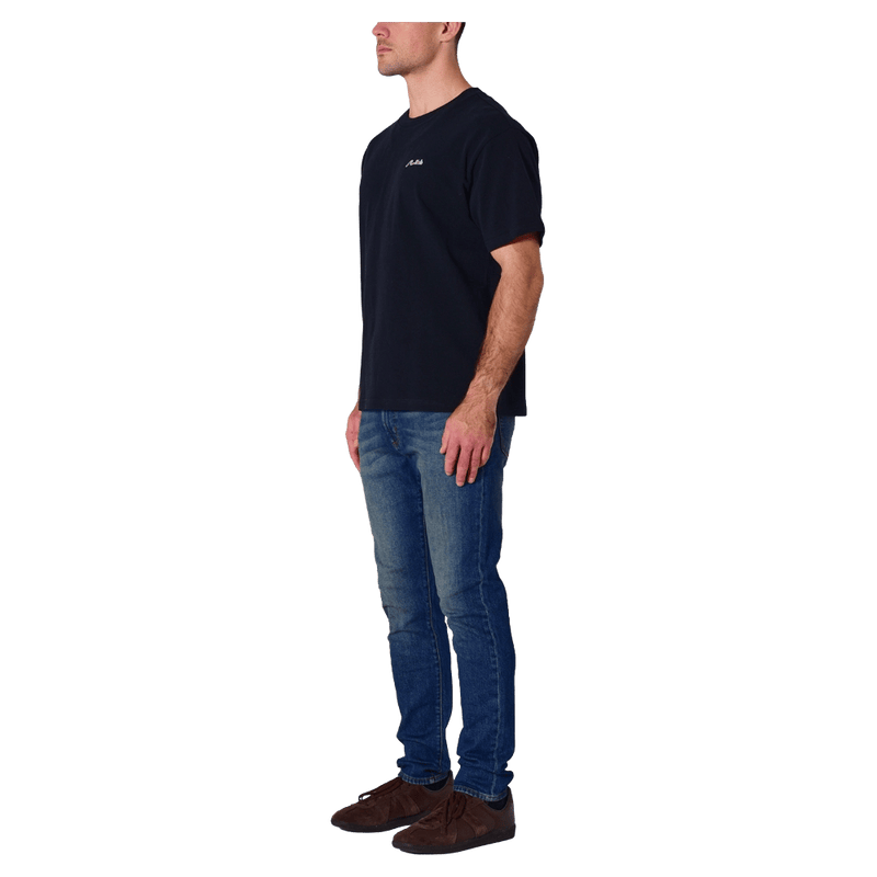 Side view of man in the Rollas Ezy Classic Tee in Colour Washed Black