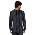 Man wearing Le Bent Midweight Thermal Crew ombre snow gum with back facing camera