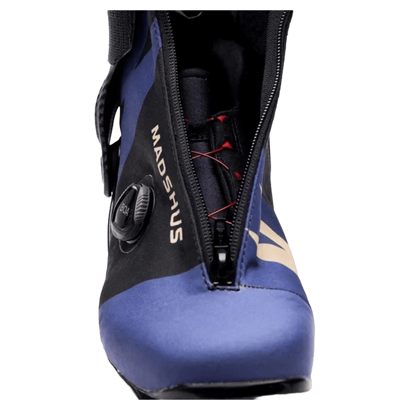Front view of a blue and black Madshus Pulse Boa Women's Skate Boot with a BOA dial, front zipper, and red internal laces.