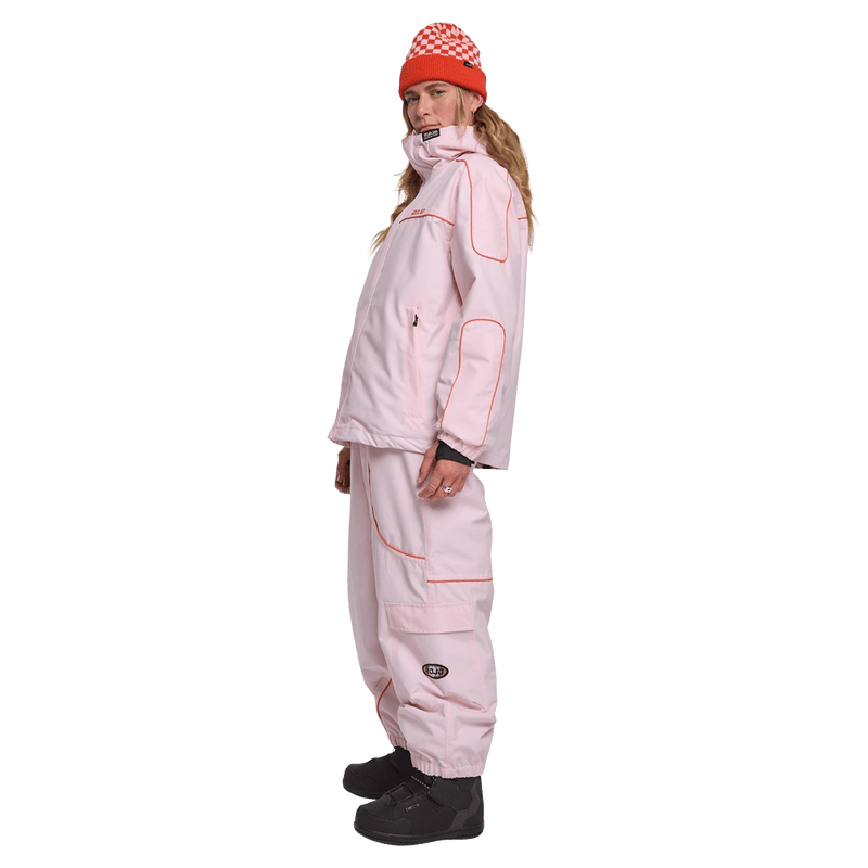 Side view of woman wearing the Rojo Nine Oh Ski Jacket - Womens in Pink-a-boo.