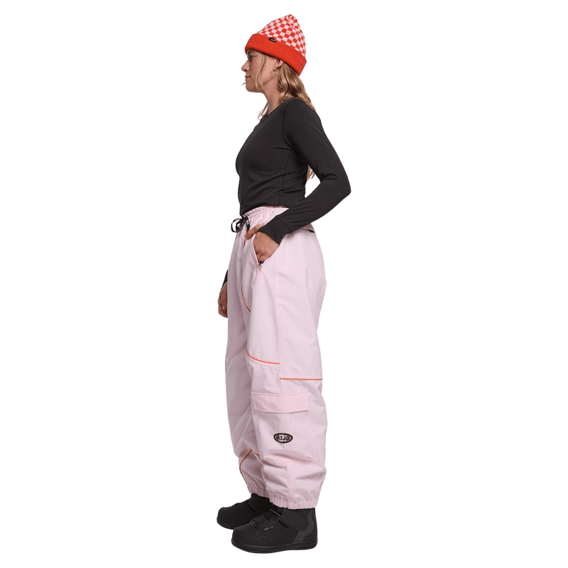 Side view of women wearing the Rojo Nine Oh Ski Pants - Womens in Pink-a-boo.