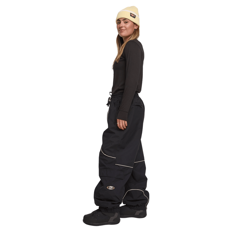 Side view of women wearing the Rojo Nine Oh Ski Pants - Womens in True Black.