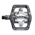 Grey One Up Components clip-in mountain bike pedal with silver metal mechanism and threaded spindle.