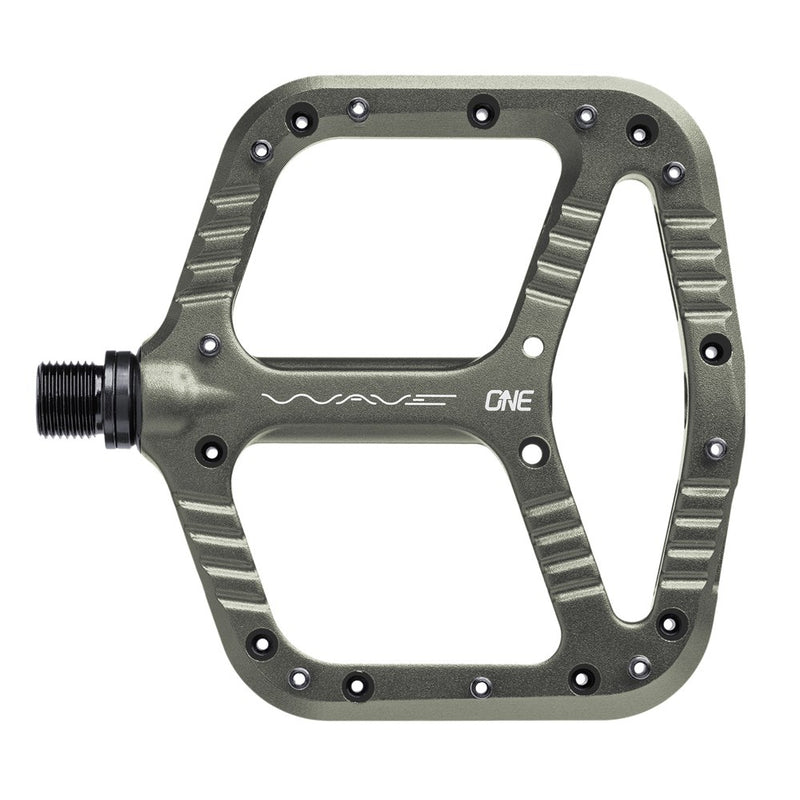 Grey One Up Components Wave flat mountain bike pedal with a large platform, ridged edges, and visible pin holes.