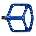 Blue One Up Components Wave flat mountain bike pedal with silver pins and textured aluminum platform.