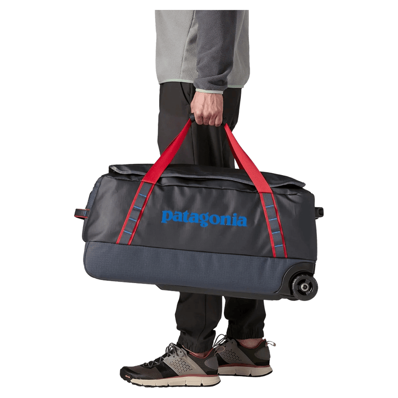 Carried view of the Patagonia Black Hole®_Wheeled_Duffle_70L_SmolderBlue_AnimatedRed 49382 Bags, 26/27 Unisex's model