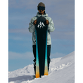 front view of Man standing on snow slope holding Jones 2027 Stratos Snowboard