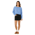 Rip Curl Emily light blue crew neck knit sweater for women, long-sleeved, worn with a black mini skirt.