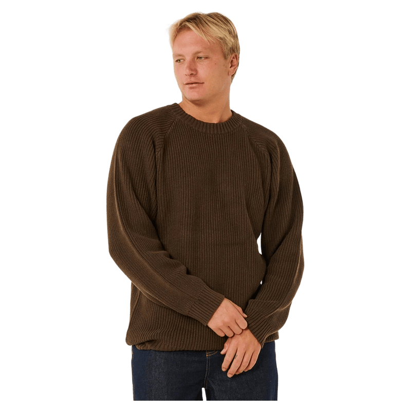 Man wearing a brown Rip Curl Premium Surf Knit Crew jumper with a ribbed texture and crew neck.