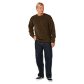 Rip Curl Premium Surf Knit Crew in dark brown, a textured knit jumper with a ribbed crew neck, worn with blue jeans.