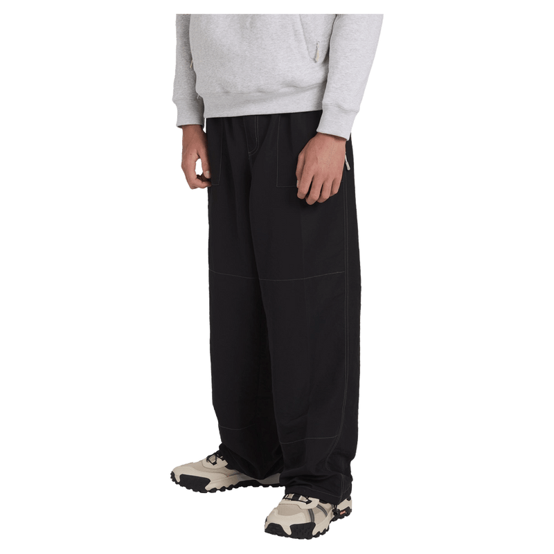 Side view of man wearing the Billabong Adiv Slant Pants in Black