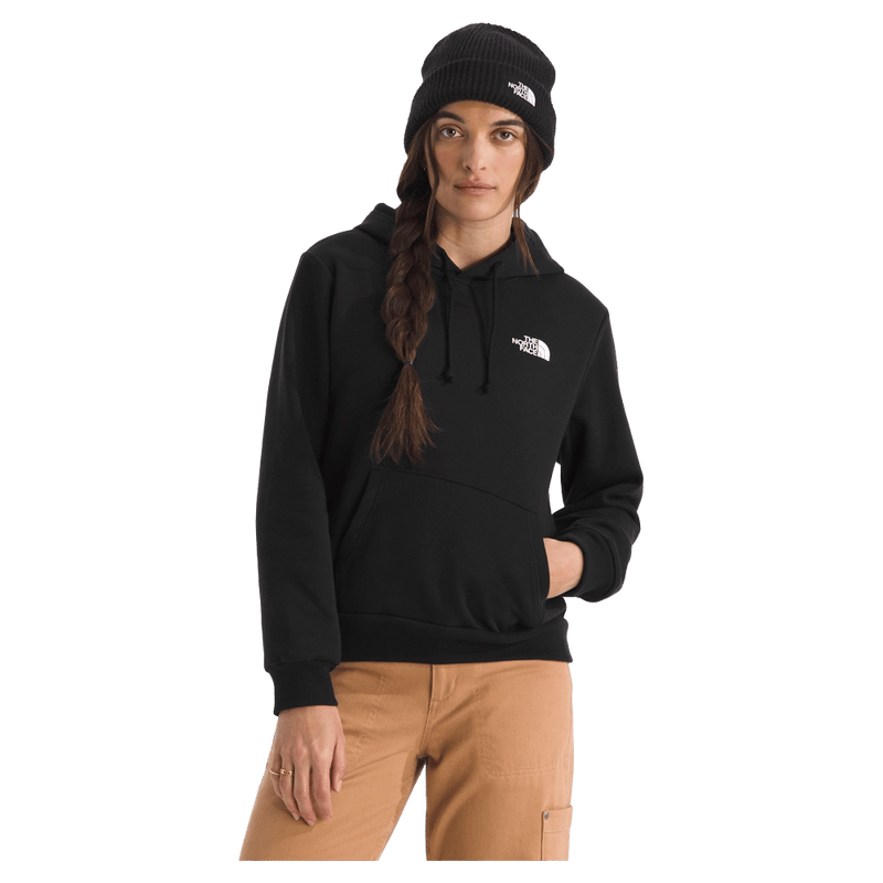 View of a woman wearing The North Face Evolution Box NSE Hoodie for Women in Black featuring a box logo graphic in white and black.