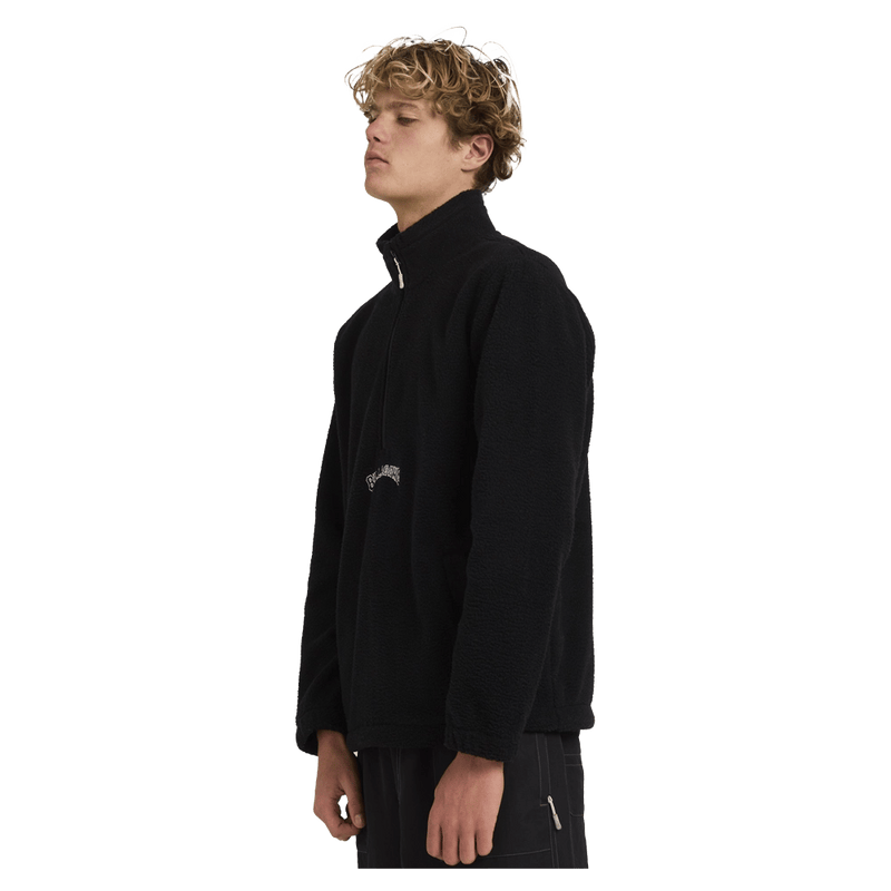 Side view of man wearing the Billabong Boundary Mockneck Jumper in Black