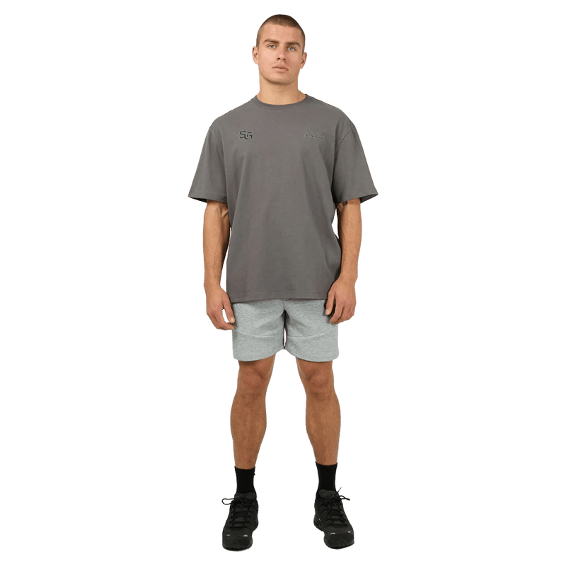 Full-side view of the St Goliath Interval Tee in Dark Grey colourway, men's model