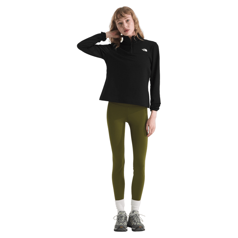 View of a woman wearing The North Face Cedar Trail Grid Fleece ¼ Zip Jacket for Women in Black featuring a quarter zip and embroidered white logo on the left chest