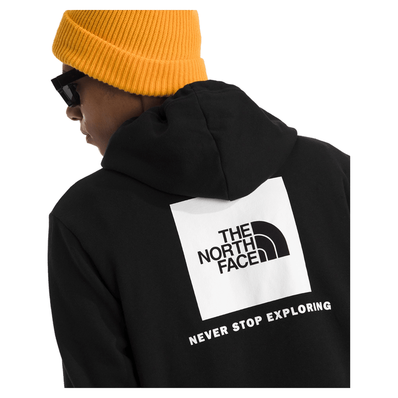 Rear view of a man wearing The North Face Evolution Box NSE Hoodie in Black featuring a box logo graphic in white and black.