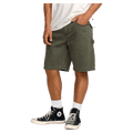 Side cropped view of a man wearing the Bad Dog Workwear Shorts from Billabong in Dark Military.