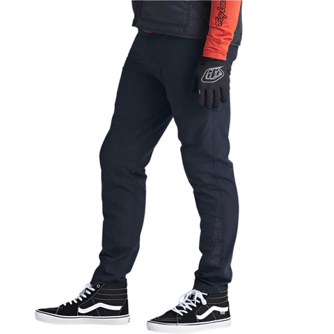 Men's TLD Ruckus pants in black on side of model.