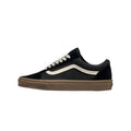 Black Vans Old Skool shoe with white side stripe, white laces, and gum brown rubber sole in a side profile view.