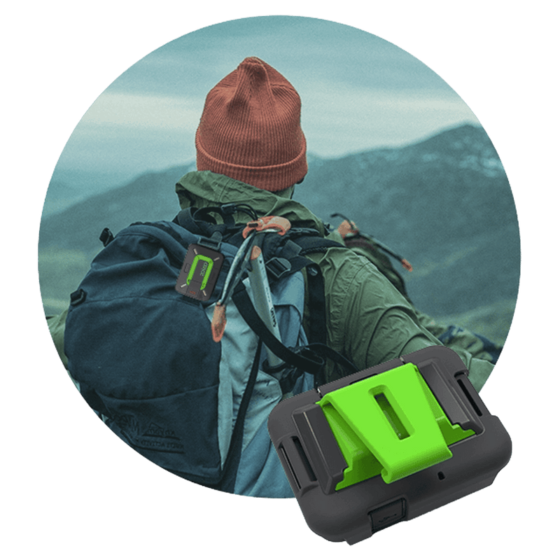Zoleo Satellite Communicator Cradle Kit with black mount and green clip, shown attached to a hiker's backpack.