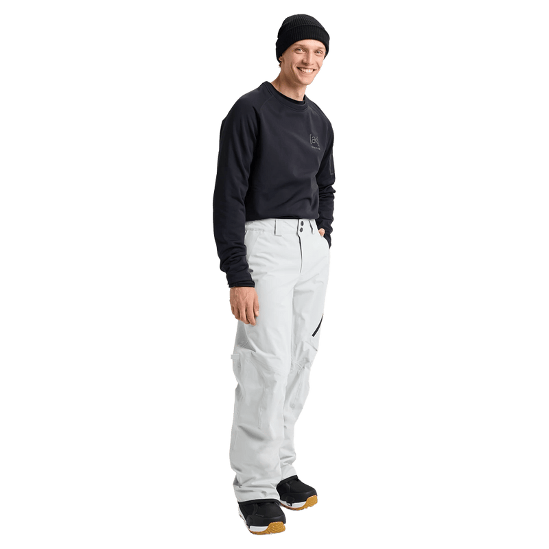 Man wearing  the Burton AK Cyclic Gore-Tex 2L Snowboard Pants in Grey-Cloud and a black fleece top