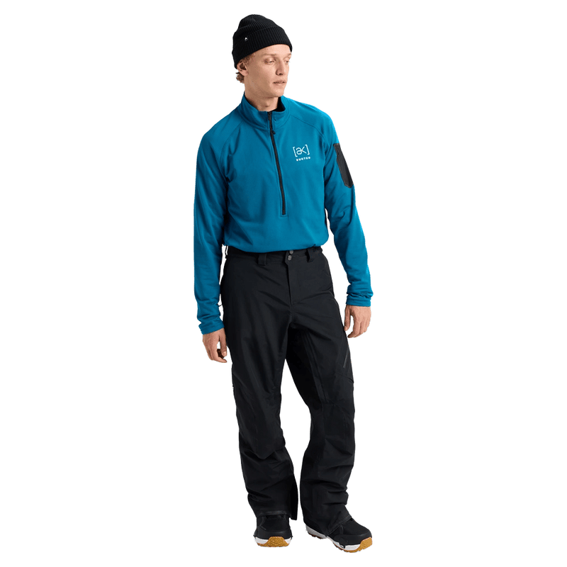 Man wearing black Burton AK Cyclic Gore-Tex 2L Snowboard Pants and a blue fleece top