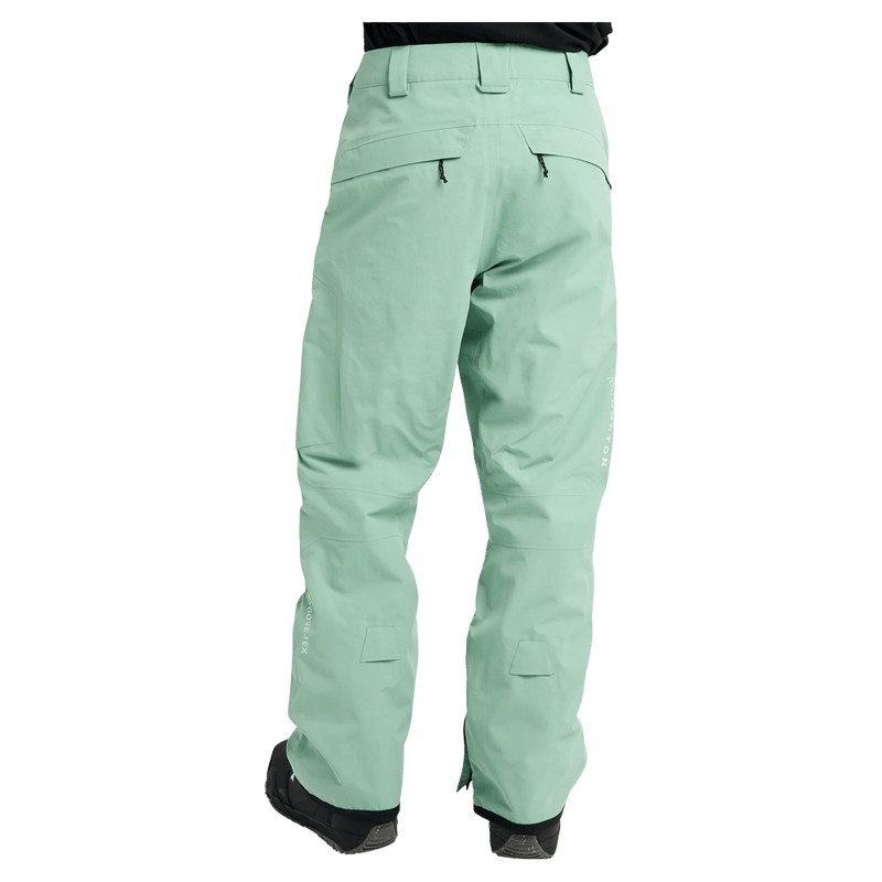 Rear view of a man wearing the Burton AK Cyclic Gore-Tex 2L Snowboard Pants in Sage Green
