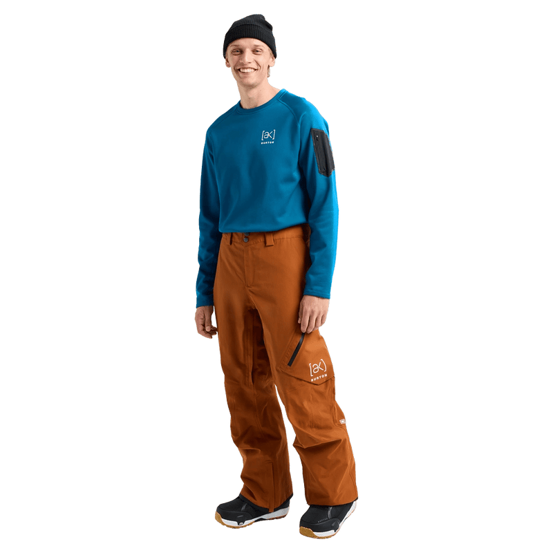 Man wearing Chestnut Brown Burton AK Cyclic Gore-Tex 2L Snowboard Pants and a blue fleece top