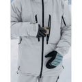 Light grey Burton AK Gore-Tex down snowboard jacket with black waterproof zippers, chest pockets, and sleeve branding.